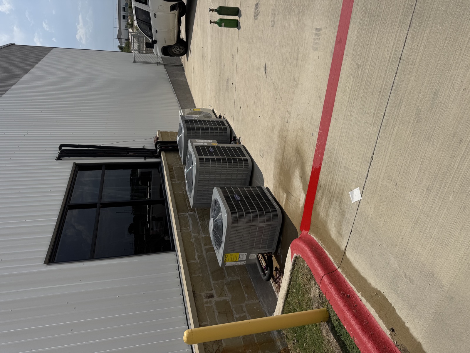 Row of commercial HVAC condenser units installed on-site