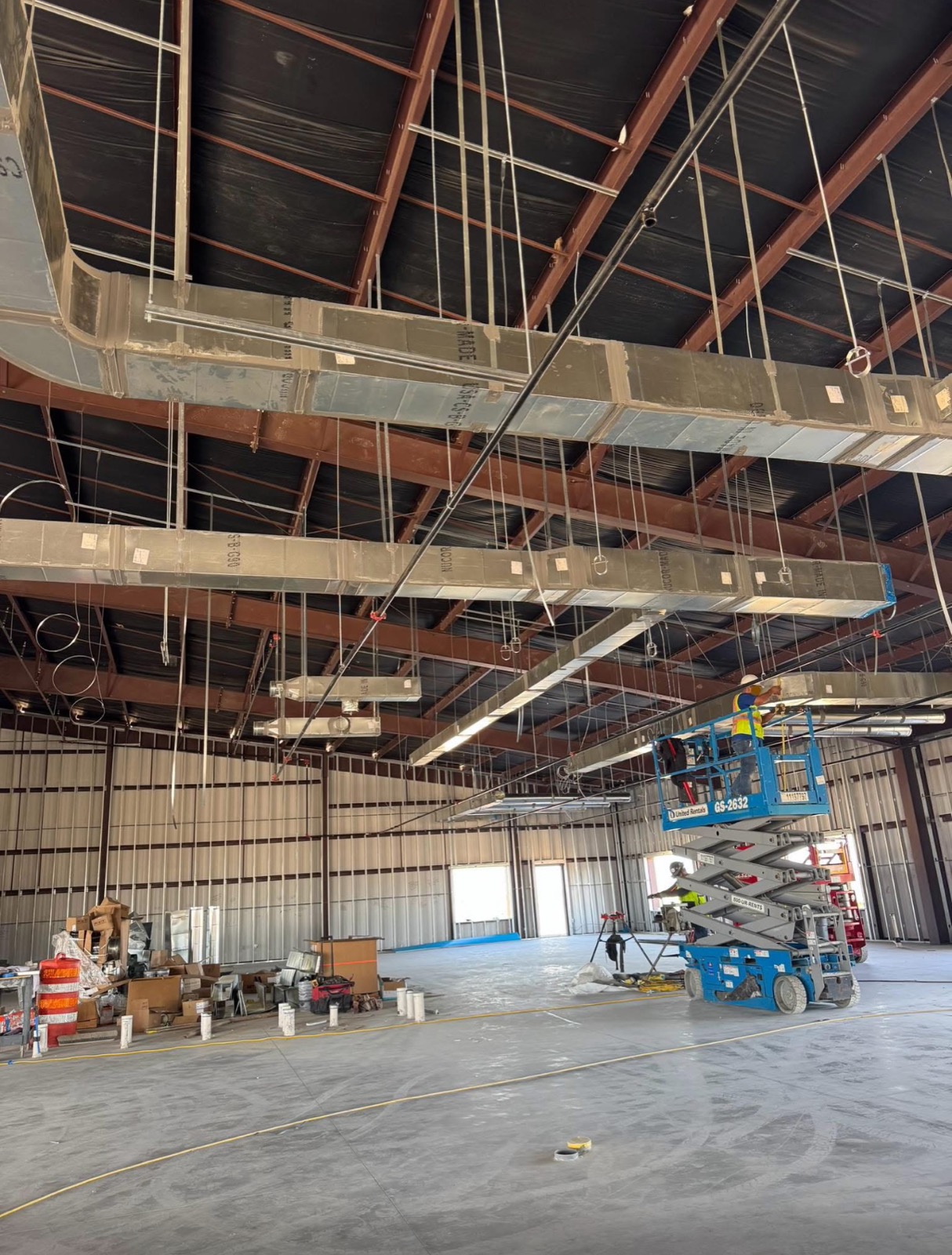 Sheet metal ductwork installed in a commercial warehouse ceiling